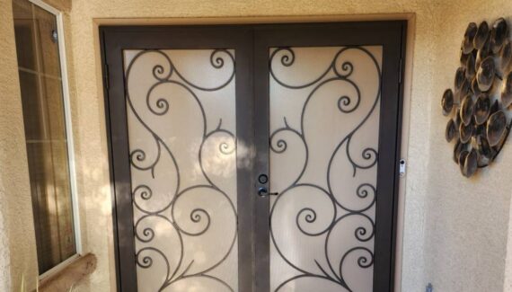 Wrought Iron swirls on cream background, French security door.