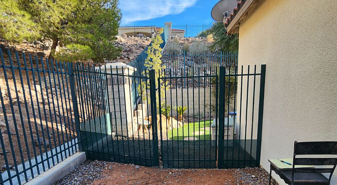 A custom wrought iron fence for a sloped backyard.