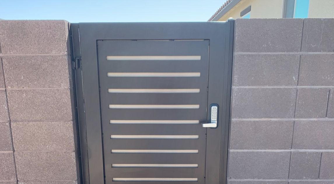dark iron metal gate in brick fencing