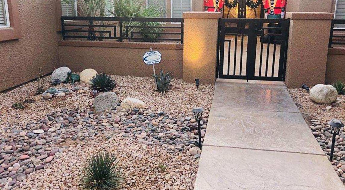 A front gate that is complemented by a xeriscape landscape design